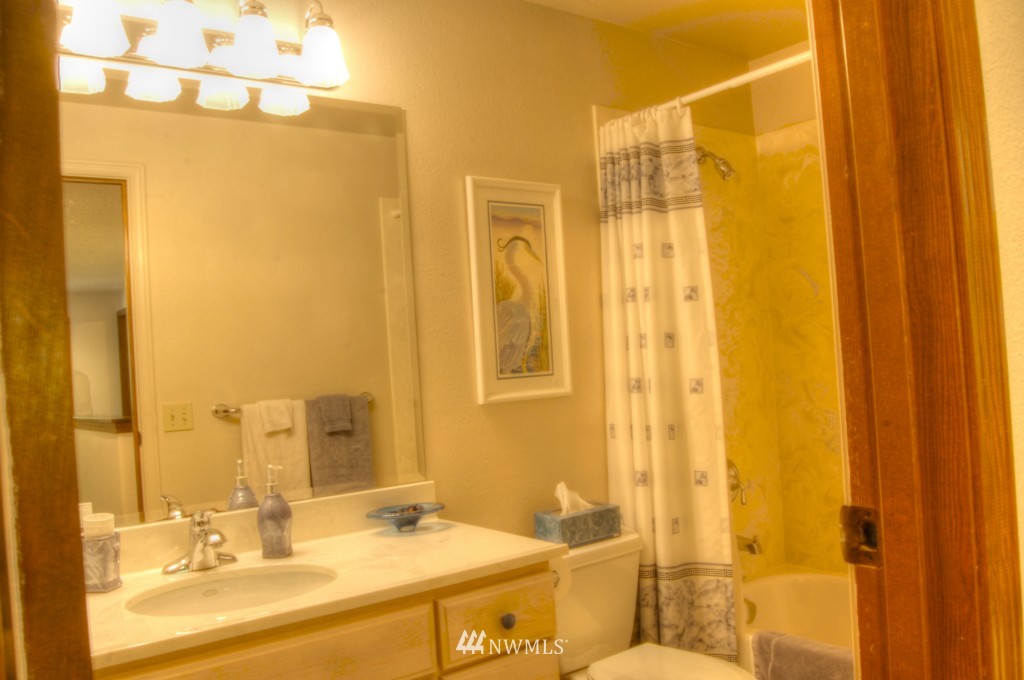 18731 129th Court Northeast Bothell, WA 98011 - Photo 21 of 24 a bathroom with a double vanity sink and a mirror