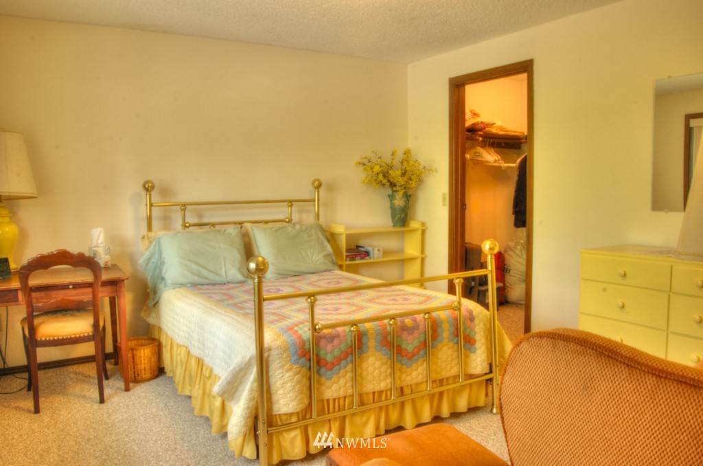 18731 129th Court Northeast Bothell, WA 98011 - Photo 22 of 24 a bedroom with a bed and painted walls