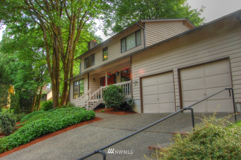 18731 129th Court Northeast Bothell, WA 98011 - Photo 5 of 24 a front view of a house with a yard and garage
