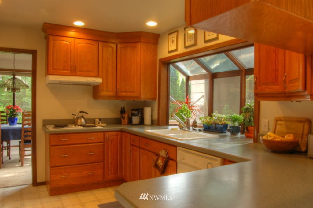 18731 129th Court Northeast Bothell, WA 98011 - Photo 7 of 24 a kitchen with stainless steel appliances granite countertop a sink a stove and cabinets