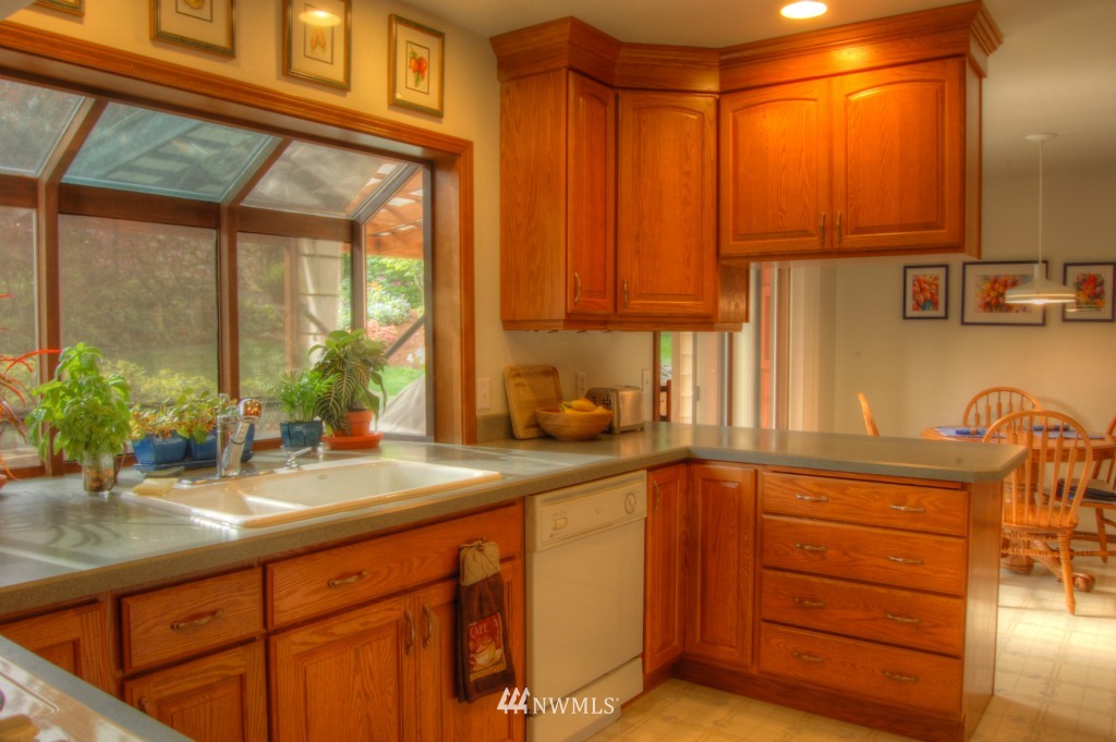 18731 129th Court Northeast Bothell, WA 98011 - Photo 8 of 24 a kitchen with stainless steel appliances granite countertop a sink and a cabinets
