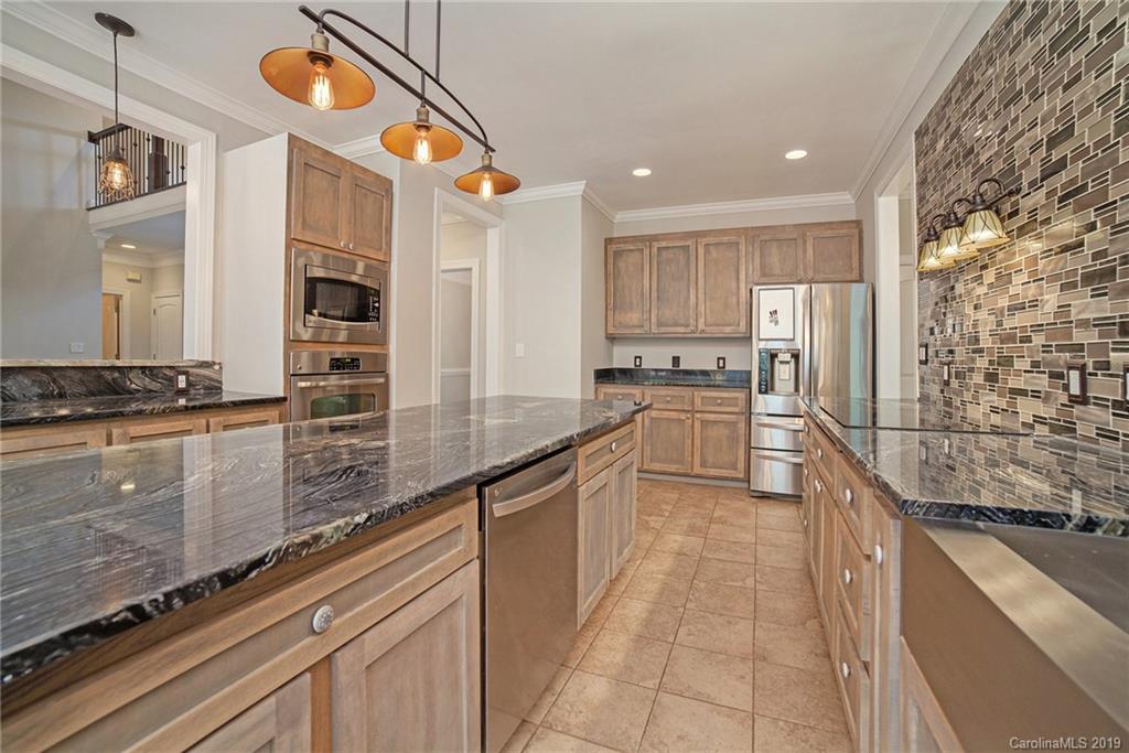 5415 Unionville Road Monroe, NC 28110 - Photo 11 of 40 a kitchen with stainless steel appliances granite countertop a sink and cabinets