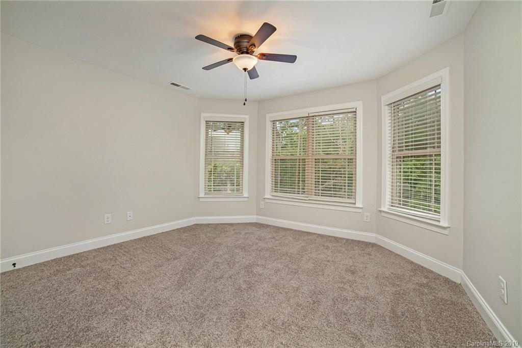 5415 Unionville Road Monroe, NC 28110 - Photo 15 of 40 an empty room with chandelier fan and windows