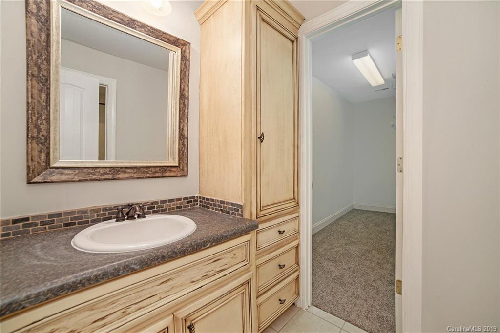 5415 Unionville Road Monroe, NC 28110 - Photo 18 of 40 a bathroom with a granite countertop sink and a mirror