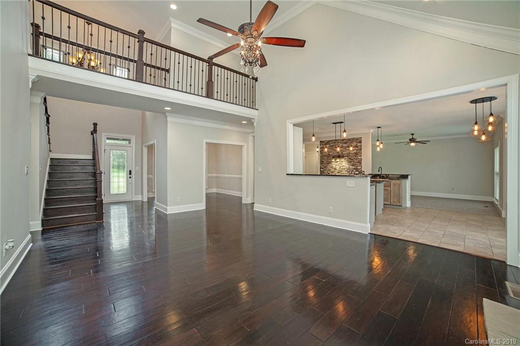 5415 Unionville Road Monroe, NC 28110 - Photo 3 of 40 a view of a hallway with wooden floor and a chandelier