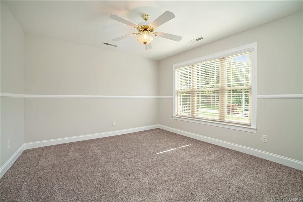 5415 Unionville Road Monroe, NC 28110 - Photo 21 of 40 an empty room with chandelier fan and windows