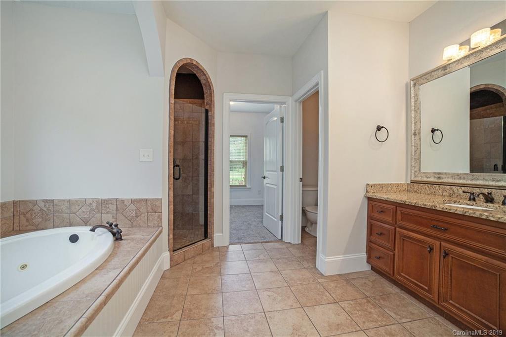 5415 Unionville Road Monroe, NC 28110 - Photo 26 of 40 a bathroom with a tub sink and mirror
