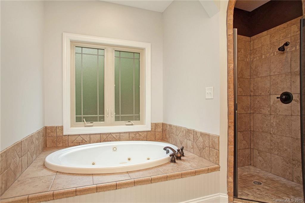 5415 Unionville Road Monroe, NC 28110 - Photo 28 of 40 a bathroom with a bathtub and shower