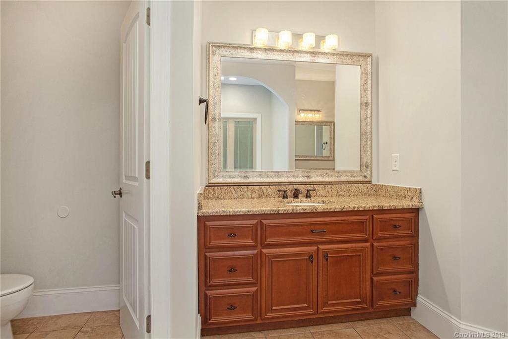 5415 Unionville Road Monroe, NC 28110 - Photo 29 of 40 a bathroom with a granite countertop sink a toilet and a mirror