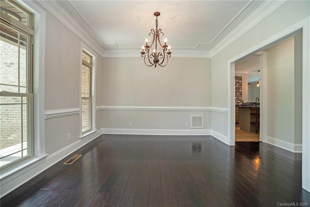 5415 Unionville Road Monroe, NC 28110 - Photo 5 of 40 an empty room with wooden floor door and windows