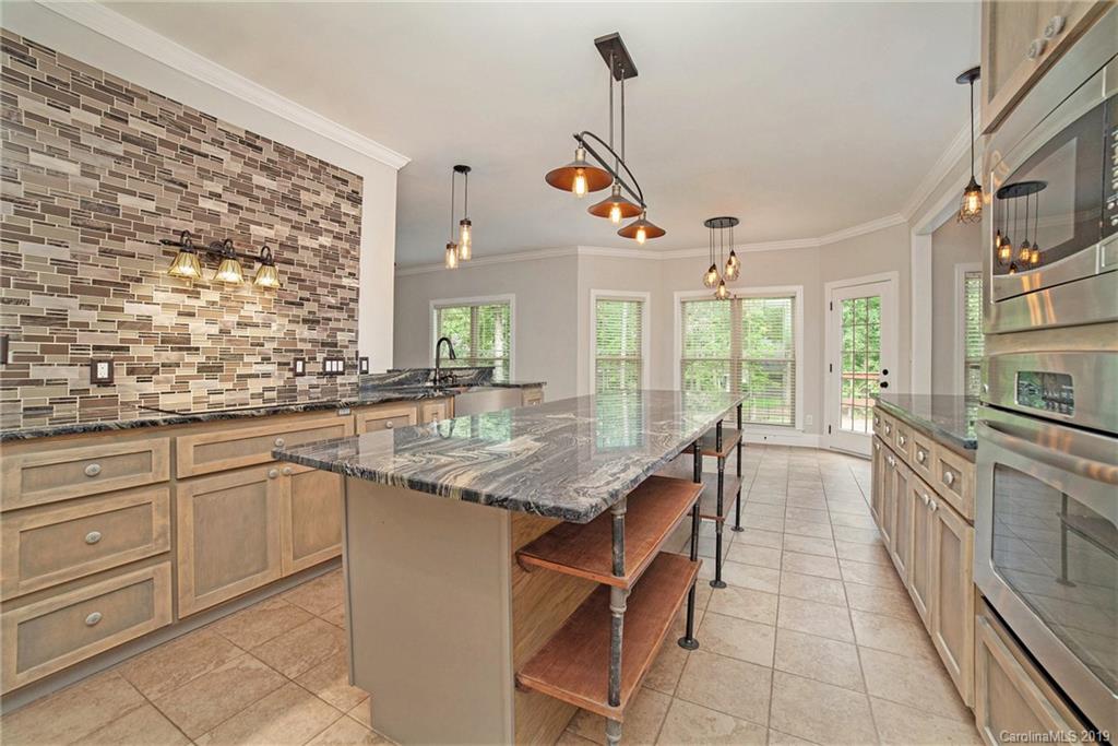 5415 Unionville Road Monroe, NC 28110 - Photo 8 of 40 a kitchen with stainless steel appliances granite countertop a stove a sink and a refrigerator