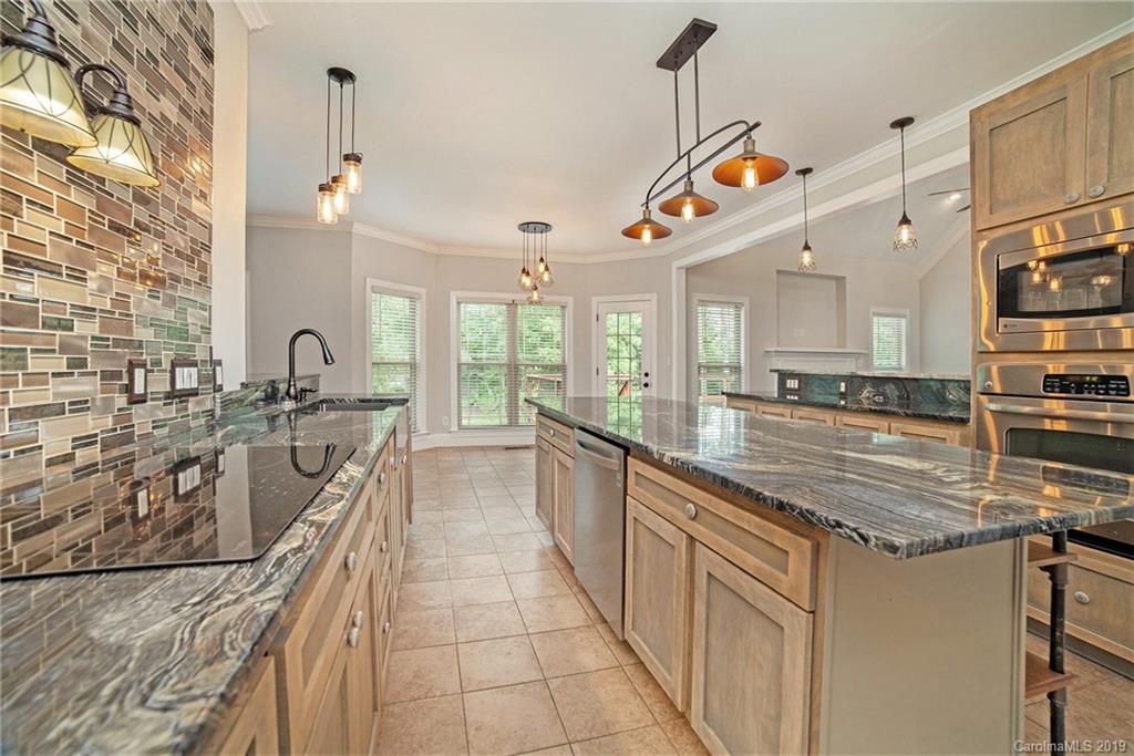 5415 Unionville Road Monroe, NC 28110 - Photo 9 of 40 a kitchen with stainless steel appliances granite countertop a sink and a stove