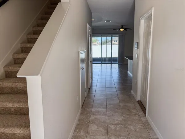 a view of a hallway with wooden floor and staircase
