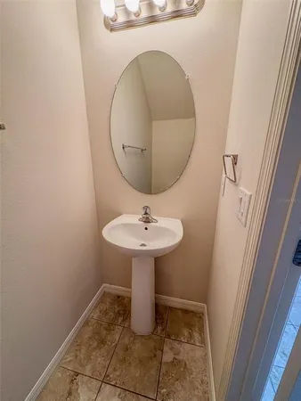 a bathroom with a sink and mirror