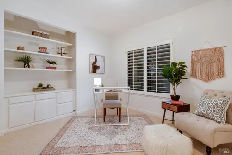 a bedroom with a bed and a potted plant