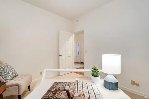 a bedroom with a bed and painting on the wall