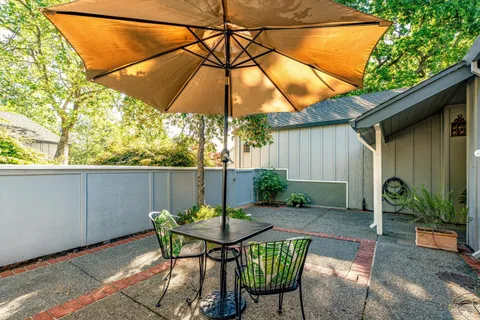 a view of a balcony with table and chairs