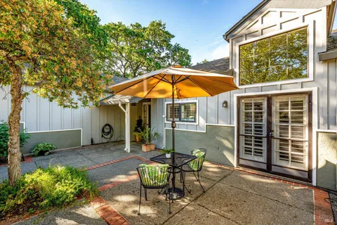 a view of a patio with a table and chairs and potted plants