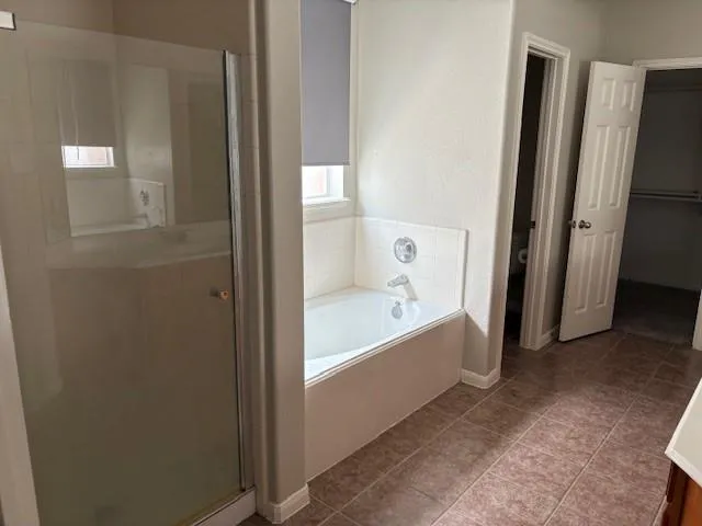 a bathroom with a bathtub and a shower