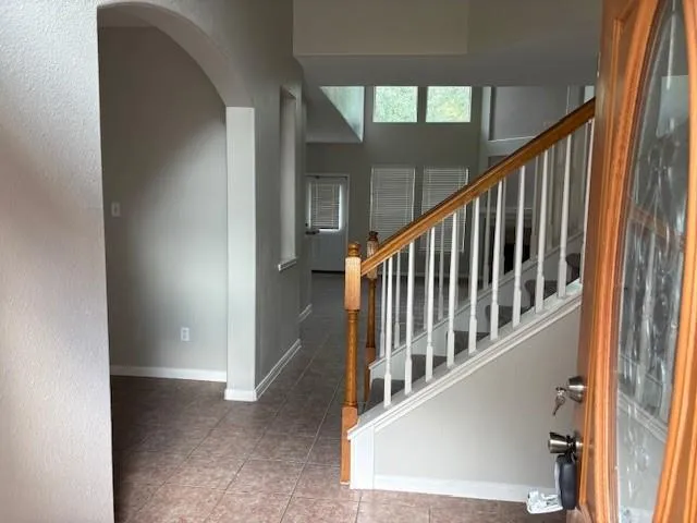 a view of staircase with railing and a window