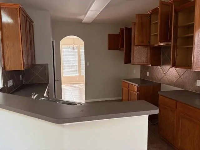 a kitchen with a sink a refrigerator and window