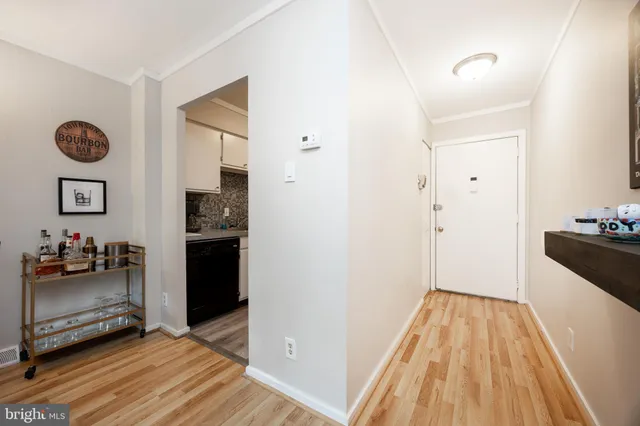 a view of a hallway view with wooden floor and furniture