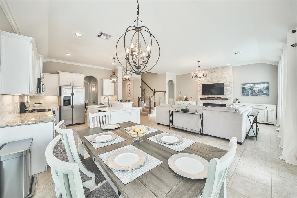 8510 Brinklow Point Drive Cypress, TX 77433 - Photo 1 of 46 a open dining room with kitchen island furniture a chandelier and kitchen view
