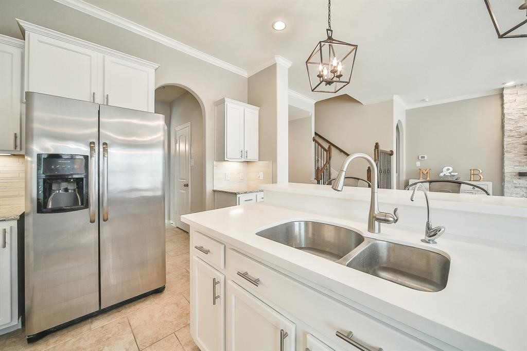 8510 Brinklow Point Drive Cypress, TX 77433 - Photo 11 of 46 a kitchen with stainless steel appliances granite countertop a refrigerator and a sink