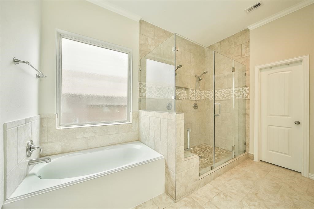 8510 Brinklow Point Drive Cypress, TX 77433 - Photo 18 of 46 a bathroom with a bathtub and a shower
