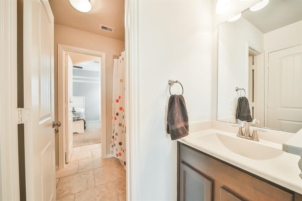 8510 Brinklow Point Drive Cypress, TX 77433 - Photo 33 of 46 a bathroom with a sink and a mirror