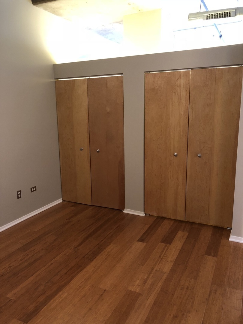 6 South Laflin Street, Unit 604 Chicago, IL 60607 - Photo 11 of 17 a view of an empty room with wooden floor