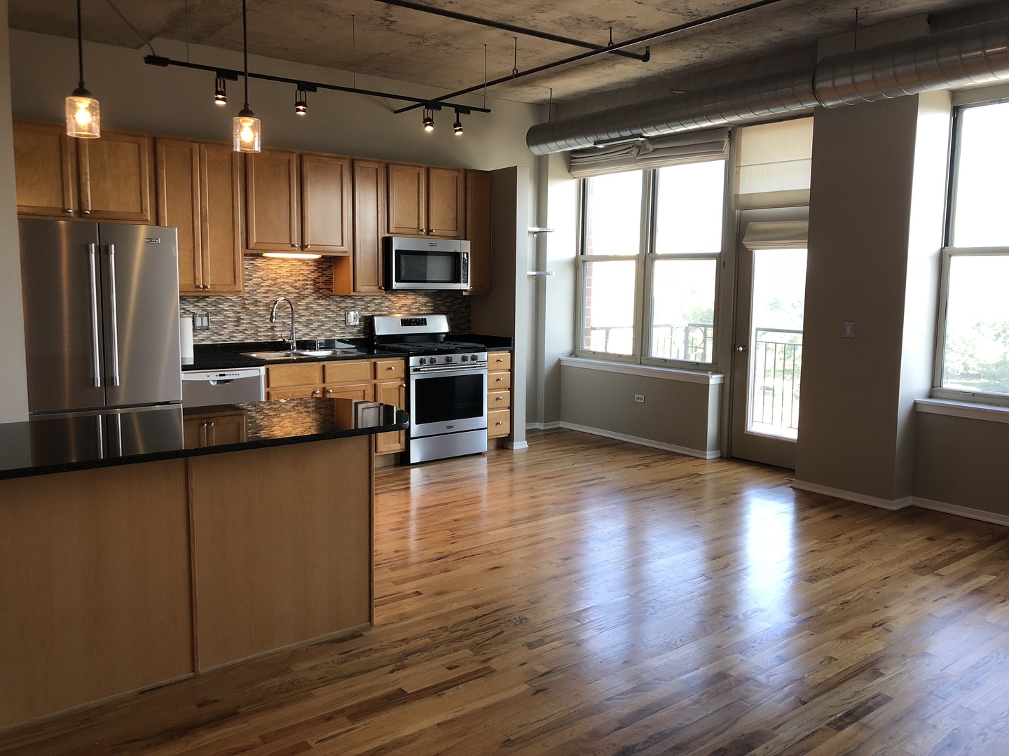 6 South Laflin Street, Unit 604 Chicago, IL 60607 - Photo 3 of 17 a kitchen with stainless steel appliances granite countertop a refrigerator a stove top oven a sink and a hard wood floors