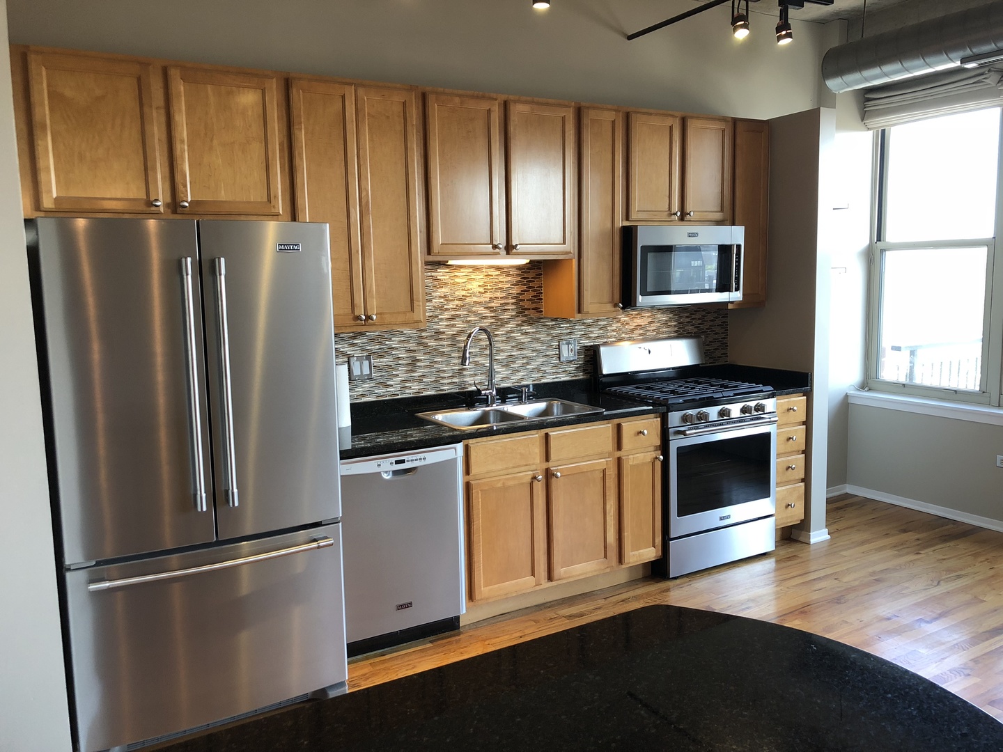 6 South Laflin Street, Unit 604 Chicago, IL 60607 - Photo 9 of 17 a kitchen with stainless steel appliances a refrigerator sink and microwave