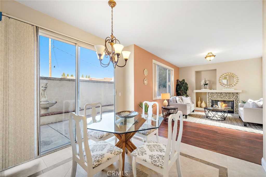 8971 Poinsettia Lane Garden Grove, CA 92841 - Photo 14 of 34 a view of a dining room with furniture a chandelier and wooden floor