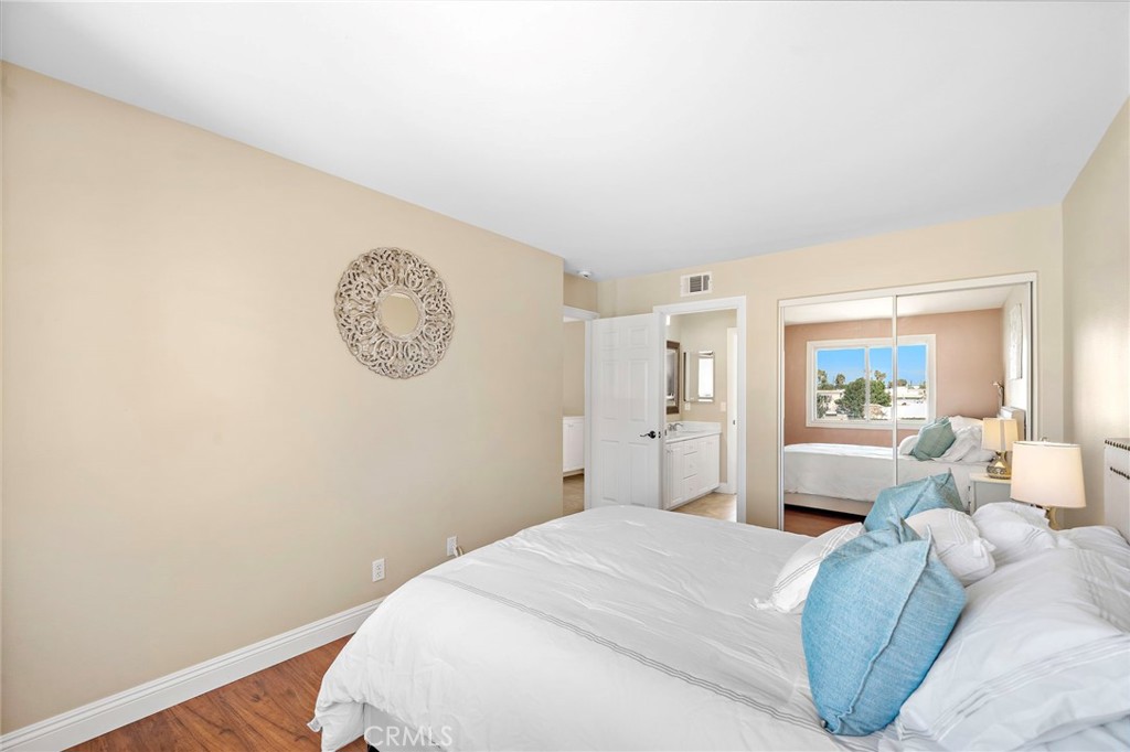 8971 Poinsettia Lane Garden Grove, CA 92841 - Photo 26 of 34 a bedroom with a bed and a chandelier