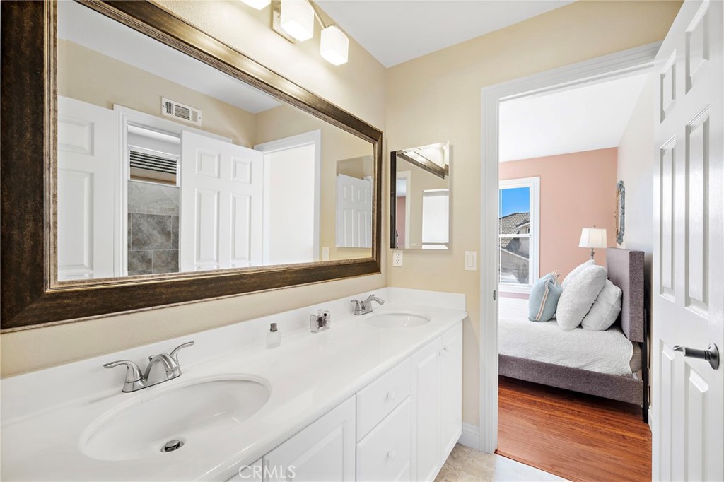 8971 Poinsettia Lane Garden Grove, CA 92841 - Photo 27 of 34 a en suite bathroom with sink and mirror