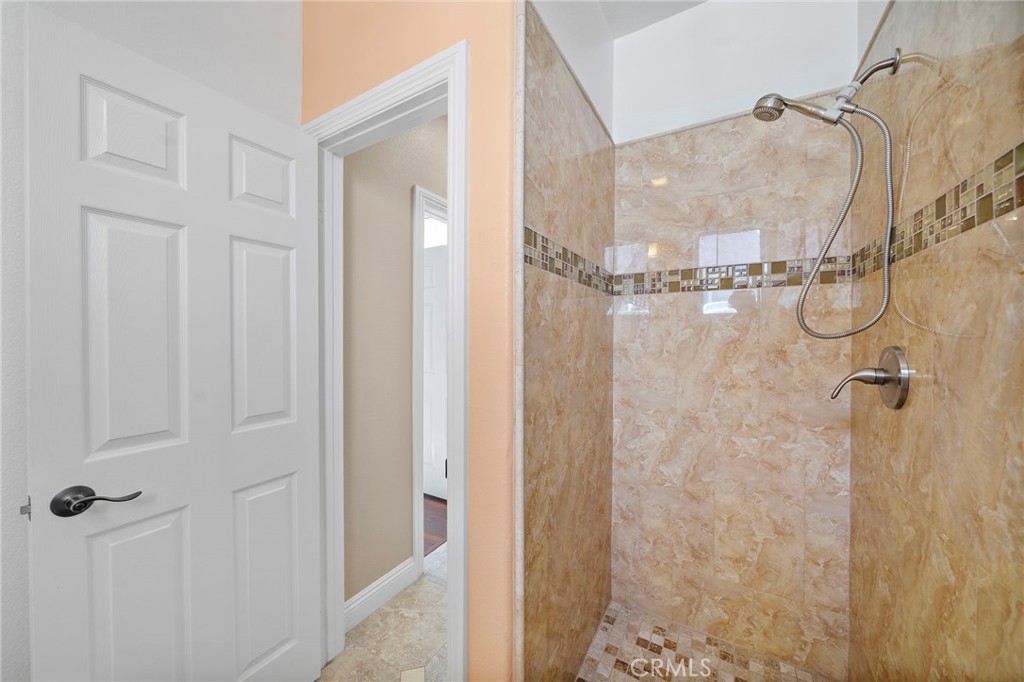 8971 Poinsettia Lane Garden Grove, CA 92841 - Photo 5 of 34 a bathroom with a glass shower door