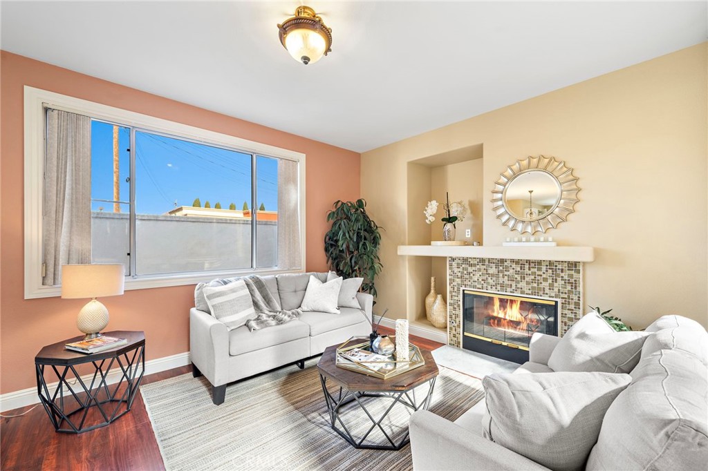 8971 Poinsettia Lane Garden Grove, CA 92841 - Photo 8 of 34 a living room with furniture and a fireplace