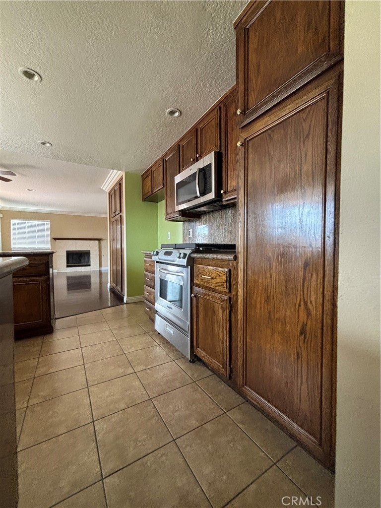 17092 Whispering Brook Way Riverside, CA 92503 - Photo 13 of 74 a kitchen with stainless steel appliances granite countertop a refrigerator and a stove top oven