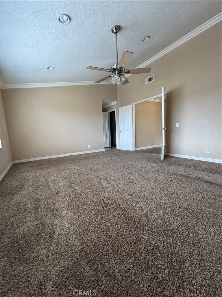 17092 Whispering Brook Way Riverside, CA 92503 - Photo 15 of 74 an empty room with a empty space and a ceiling fan