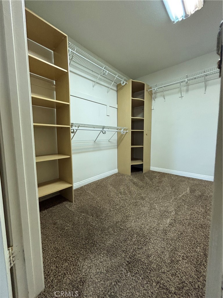 17092 Whispering Brook Way Riverside, CA 92503 - Photo 23 of 74 a view of walk in closet with empty racks