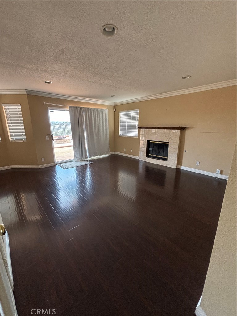 17092 Whispering Brook Way Riverside, CA 92503 - Photo 3 of 74 an empty room with wooden floor and fireplace