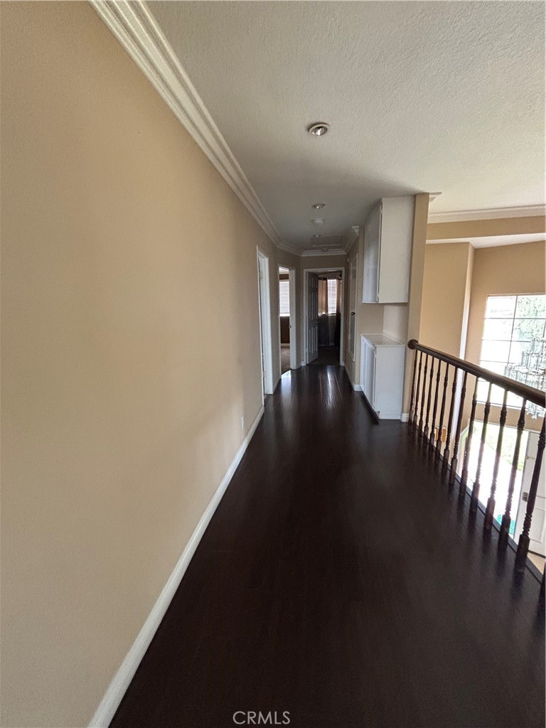 17092 Whispering Brook Way Riverside, CA 92503 - Photo 36 of 74 a view of a hallway with wooden floor and a window