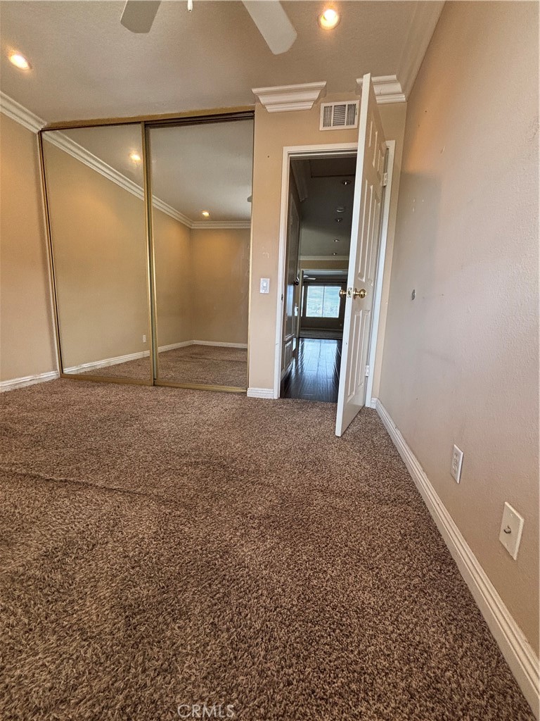 17092 Whispering Brook Way Riverside, CA 92503 - Photo 45 of 74 an empty room with closet and wooden door