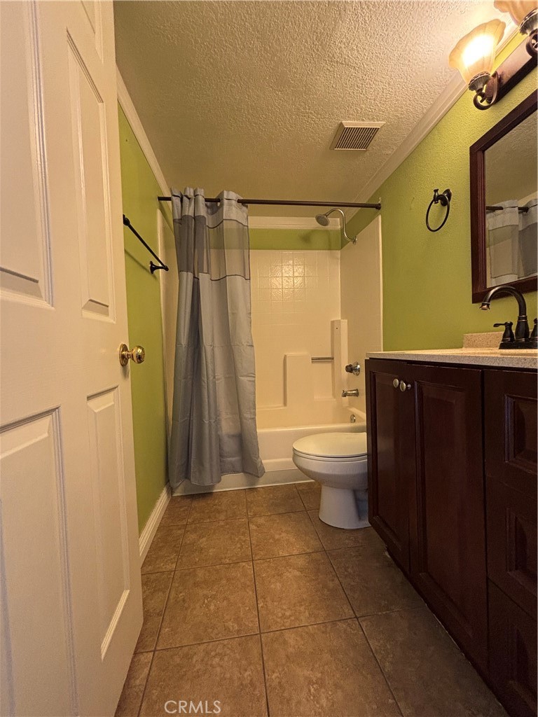 17092 Whispering Brook Way Riverside, CA 92503 - Photo 54 of 74 a bathroom with a sink a toilet and shower