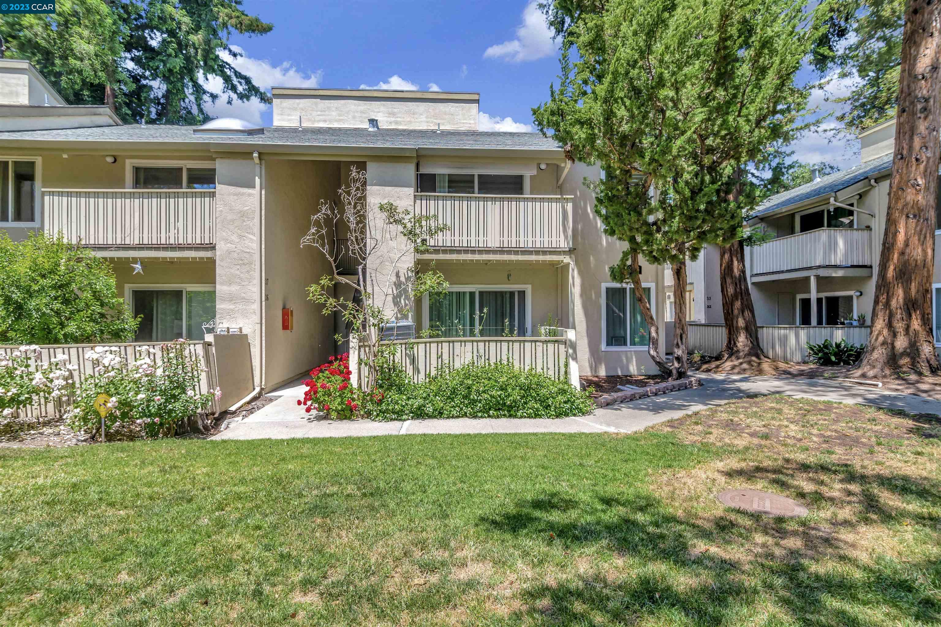 2708 Oak Road, Unit 35 Walnut Creek, CA 94597 - Photo 1 of 1 a front view of a house with a yard and porch