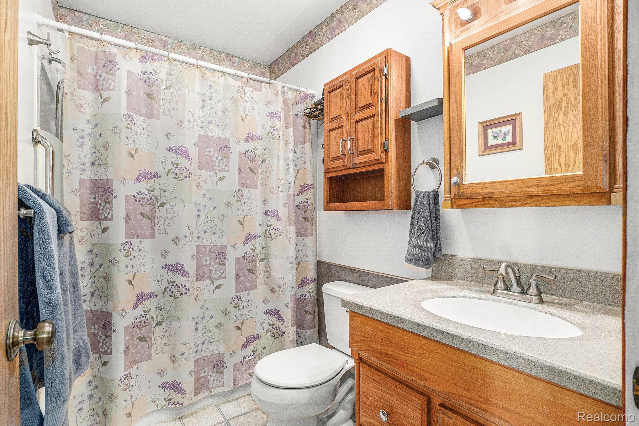 5627 West Fairgrove Road Fairgrove, MI 48733 - Photo 12 of 26 Full bath with vanity and light tile patterned floors