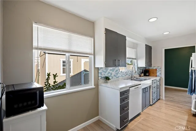 a kitchen with stainless steel appliances a refrigerator and a stove top oven