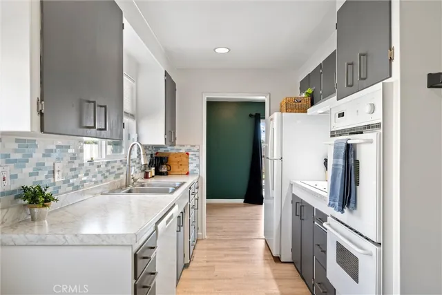 a kitchen with stainless steel appliances a sink stove and cabinets