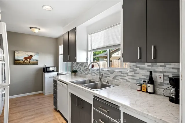 a kitchen with a sink and a refrigerator